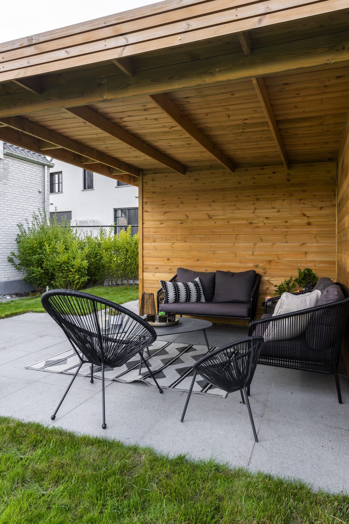 Zithoek onder luifel tuinhuis