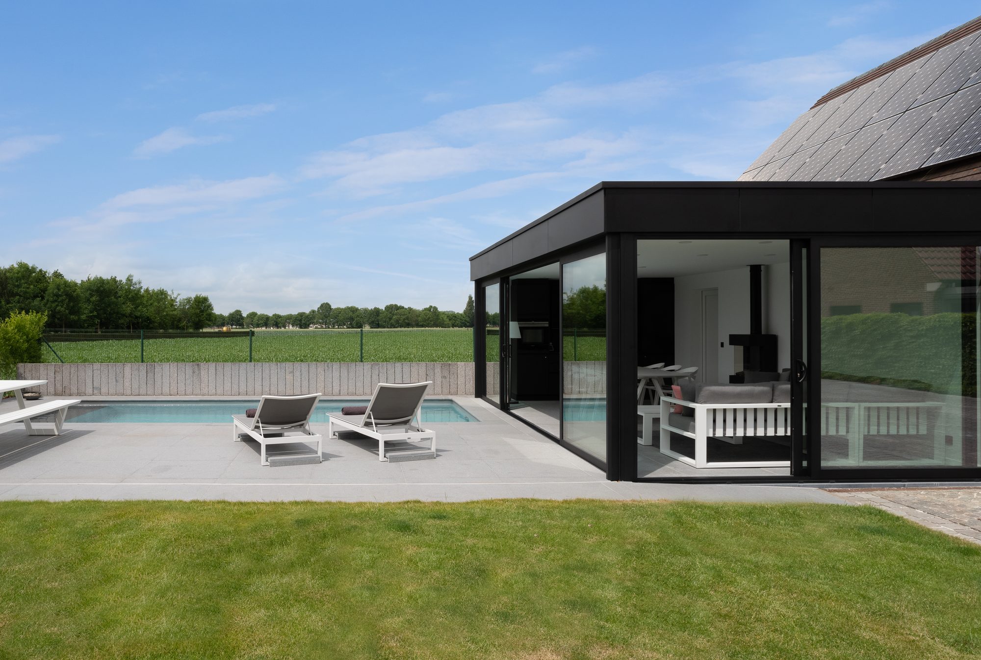 Design poolhouse in zwarte Trespa en met zwarte aluminium ramen